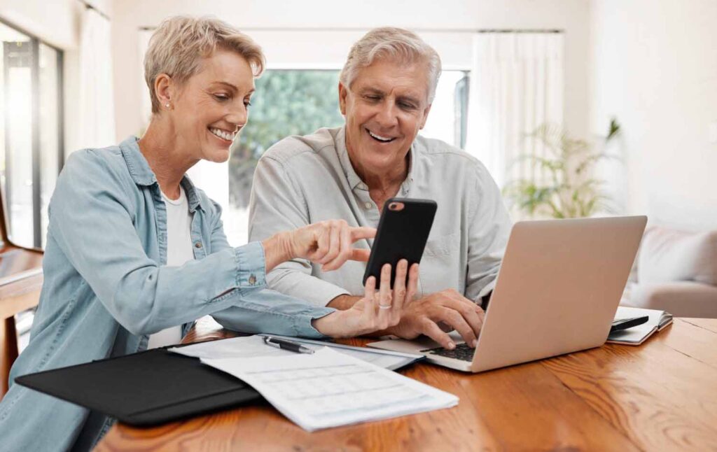 couple sitting at their kitchen table researching annuity for retirement