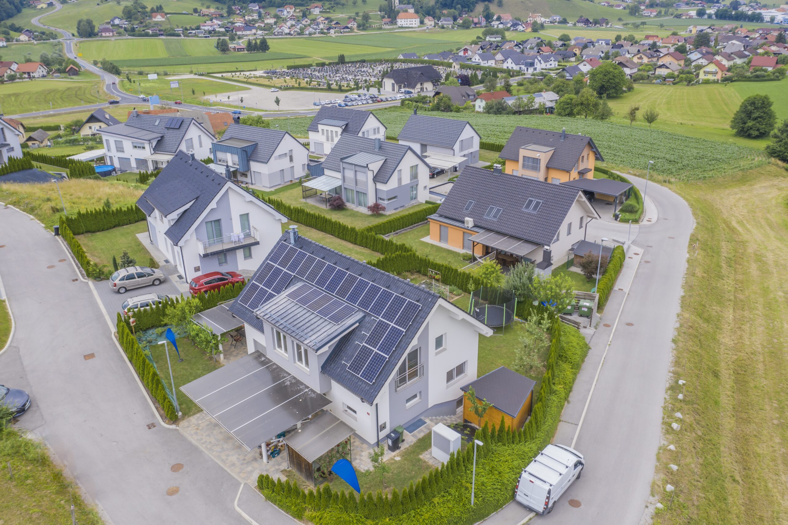 A high angle shot of private houses with solar panels on the roofs