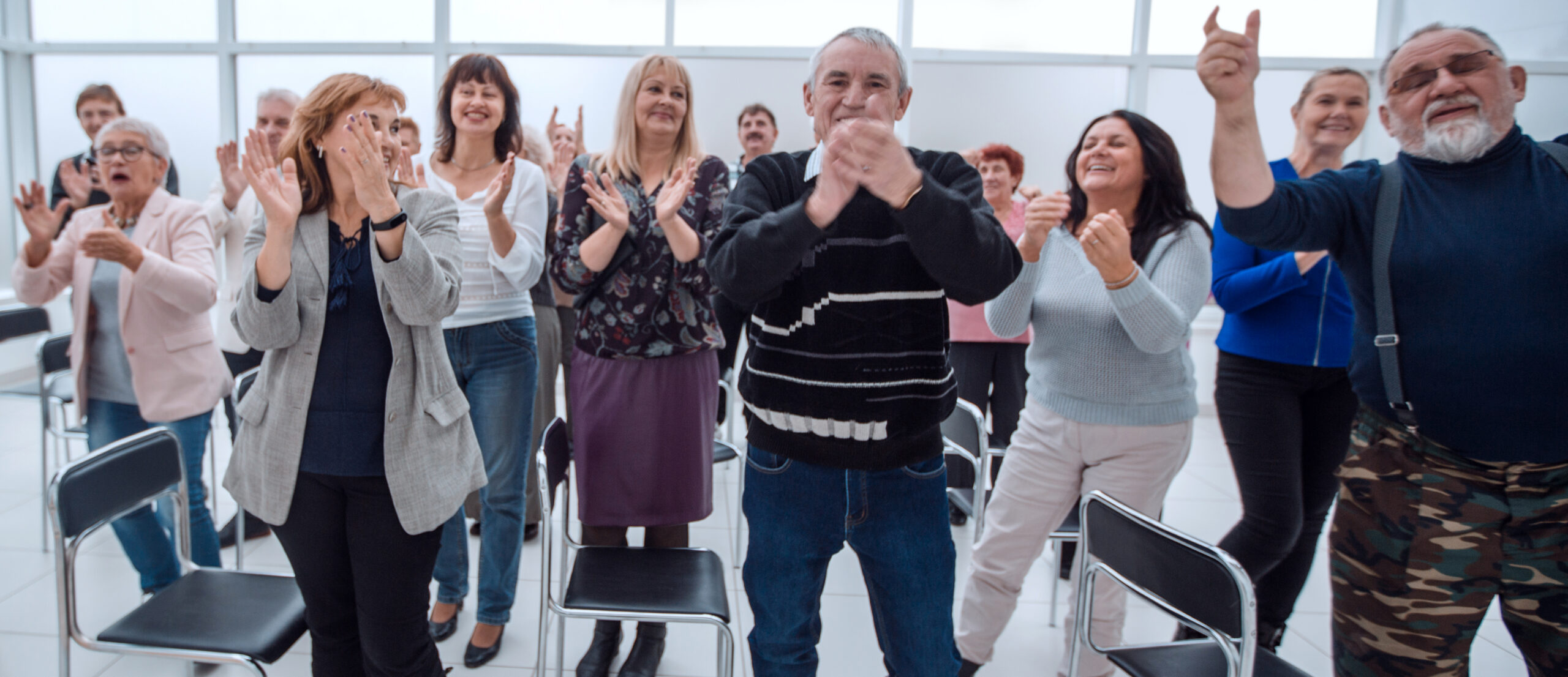 group of mature people applaud after meeting in full growth