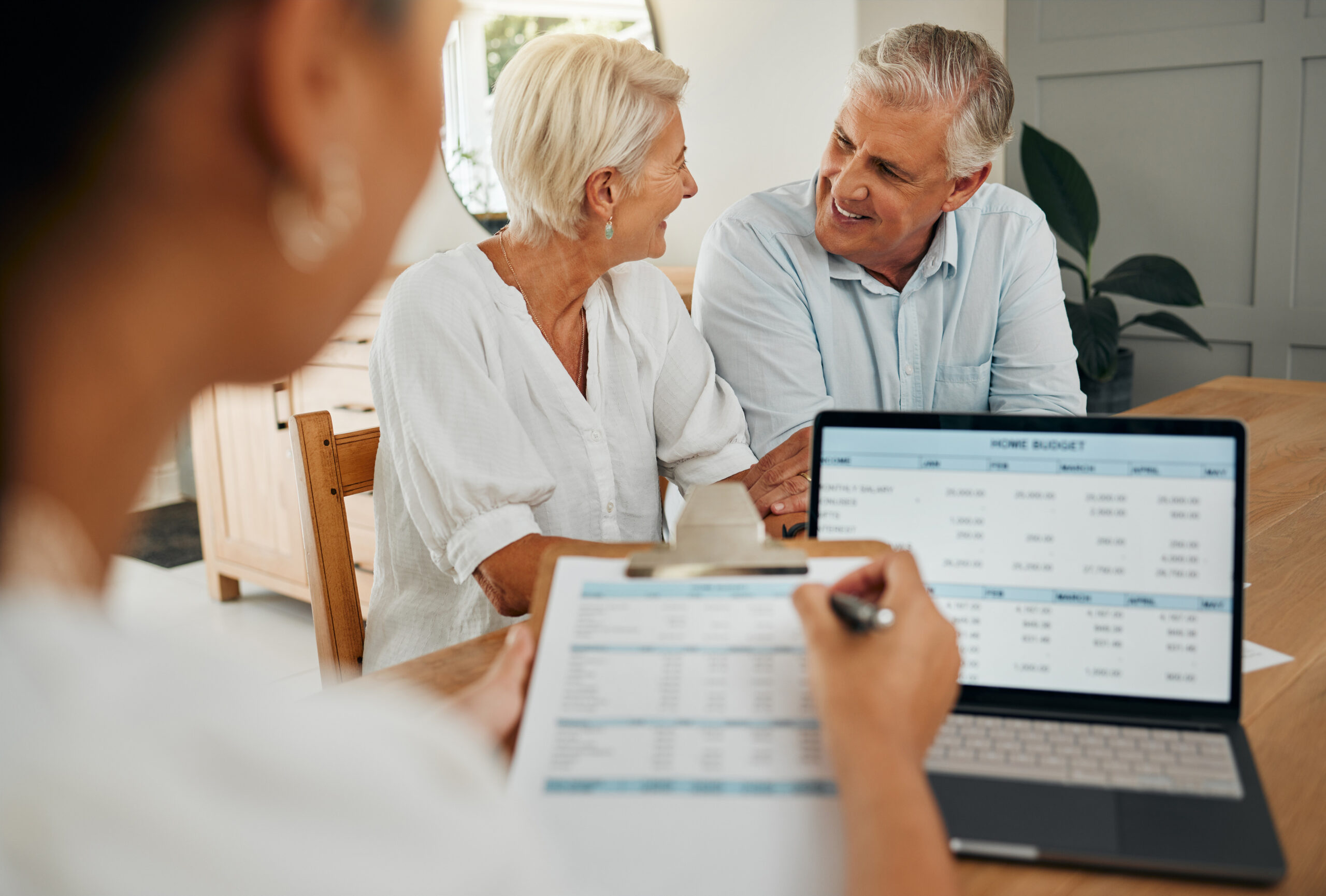 Senior couple, laptop and financial advisor in retirement finance planning paper, budget loan or investment insurance documents. Smile, happy or excited man and woman consulting funeral policy worker.