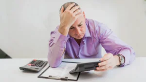 man is visibly worried due to having loss of income due to market downturns in retirement